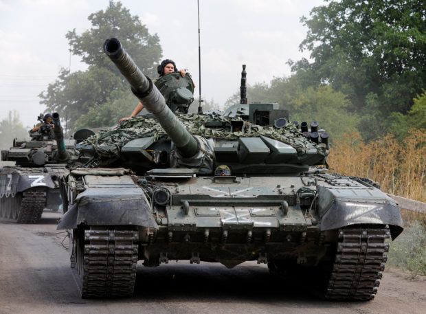 Service members of pro-Russian troops drive tanks in the course of Ukraine-Russia conflict near the settlement of Olenivka in the Donetsk region, Ukraine July 29, 2022. REUTERS/Alexander Ermochenko