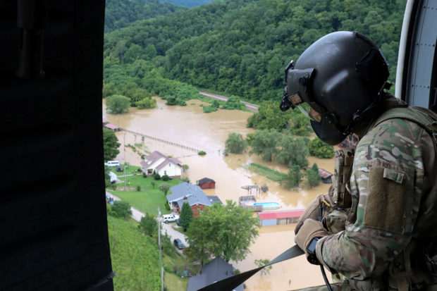 A Kentucky National Guard flight crew from 2/147th Bravo Co. flies over a flooded area in response to a declared state of emergency in eastern Kentucky, U.S. July 29, 2022. U.S. Army National Guard/Sgt. Jesse Elbouab/Handout via REUTERS