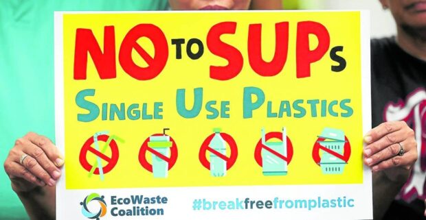 EcoWaste Coalition placard saying: No to SUPS, Singe Use Plastics. STORY: Cebu town bans single-use plastics two days a week