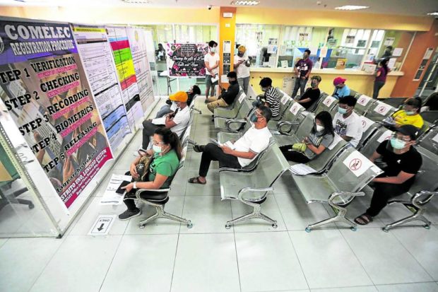 Voter registrants wait for their turn to have their biometrics taken at the office of the Commission on Elections in Quezon City in this file photo. STORY: 500,000 new voters register for barangay, SK polls in December