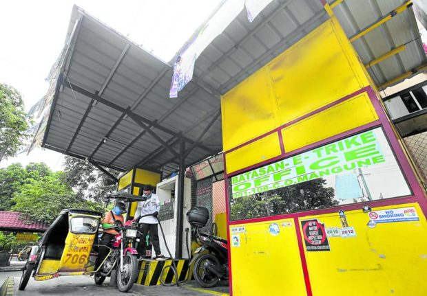 CHEAPER FUEL A tricycle driver on Monday refuels at a pocket gasoline station built at a terminal in Barangay Batasan Hills, Quezon City. Members of Batasan Tricycle Operators and Drivers Association get a P2-discount from this station, which is a partnership between the city government and a private company. —LYN RILLON