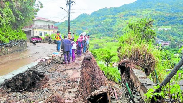  A section of a road at Barangay Poblacion in Banaue, Ifugao, has collapsed. STORY: ‘Weak’ slopes worsened Banaue floods – DPWH