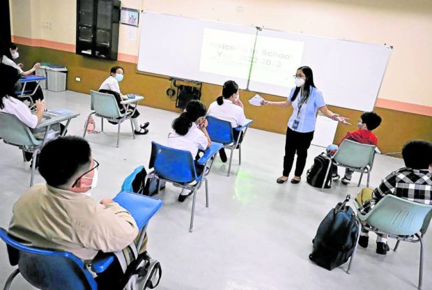 BACK TO SCHOOL Grade school students at Chiang Kai Shek College in Tondo, Manila, meet their teacher in an in-person class on July 12. STORY: 