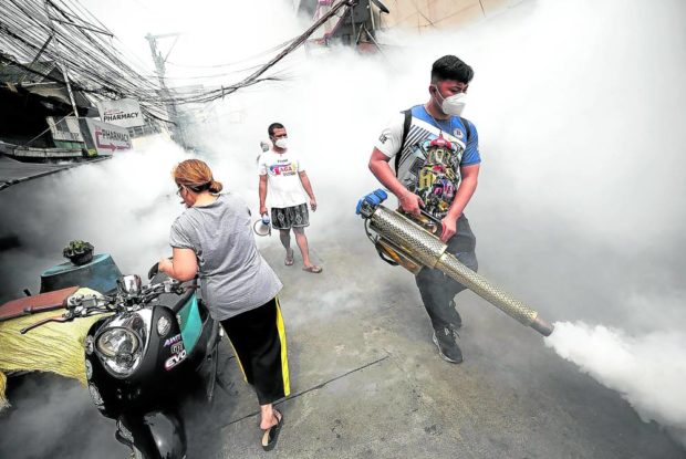 A worker from the city government of Manila conducts fogging against dengue-carrying mosquitoes in Tondo district in this July 5 photo. Other areas in the country, like Antique, are seeing an increase in dengue infections this year, prompting provincial and municipal governments to declare their localities under a state of calamity. STORY: Antique under state of calamity due to dengue