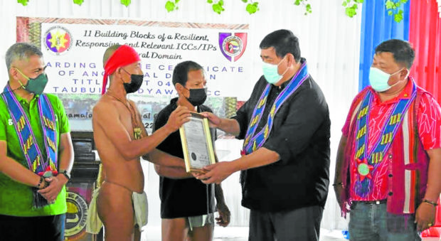 Leaders of the Mangyan tribe in Oriental Mindoro receive their first certificate of ancestral domain