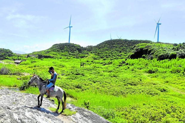 CLEAN AND SUSTAINABLE The wind farms in Burgos town, llocos Norte province, are among the country’s sources of clean energy, which the Marcos administration has committed to support and develop. Communities near the wind turbines, or “windmills,” have seen tourism activities blossom as people start visiting these coastal areas. —WILLIE LOMIBAO