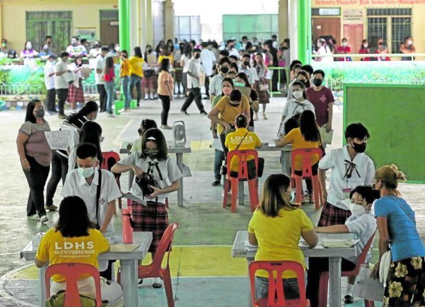 ALMOST BACK TO NORMAL Students enroll in person at Lakandula High School in Tondo, Manila, although the Department of Education says that the procedure can also be done online. —RICHARD A. REYES