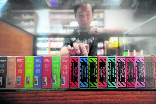 Man choosing vaping products. STORY: Bill allowing younger vapers lapses into law