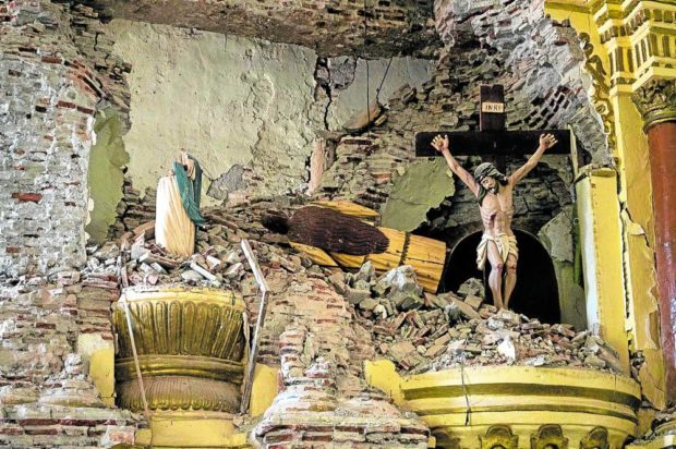SACRED BUT SCARRED  A portion of an old Catholic church in Tayum, Abra province, one of its treasured heritage sites, is reduced to this following Wednesday’s magnitude 7 earthquake. —Reuters