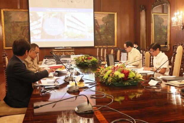 This photo shows President Ferdinand "Bongbong" Marcos Jr., middle, and energy officials at the Malacanang reviewing written reports about high oil and fuel prices.