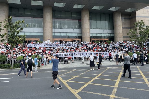 People protesting in front of a branch of the People's Bank of China in the central Chinese city of Zhengzhou. 