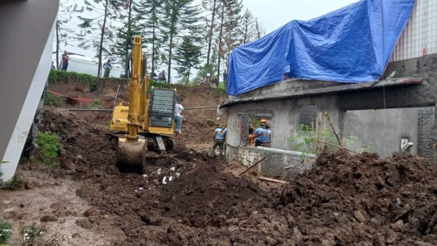 Authorities conduct a search, rescue and retrieval operation on Tuesday, July 12, 2022, a day after a concrete wall collapsed on eight construction workers at Barangay Kaybagal Central in Tagaytay City.