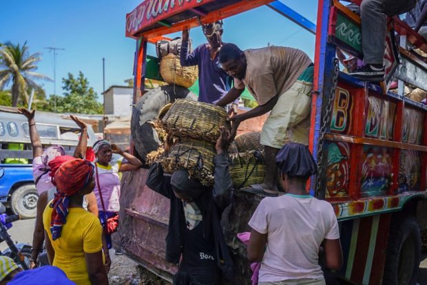 Haitians unload a truck in Port-au-Prince on July 15, 2022.