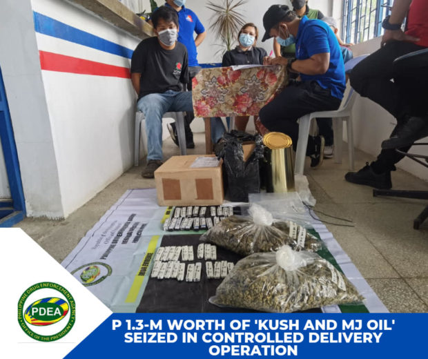 Marijuana oil and dried leaves seized from the possession of Jude Paolo Javier (seated left) after claiming on Wednesday in Kidapawan City the package shipped from California. (Photo from PDEA-12)
