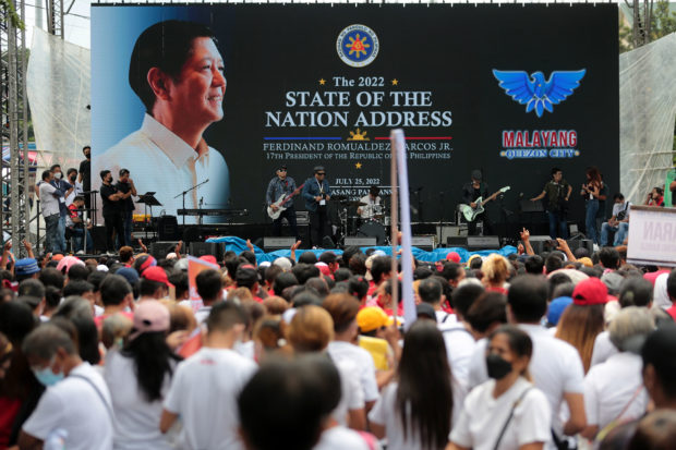 Supporters of President Marcos gather a few meters away from the House of Representatives in Quezon City on Monday to listen to his first State of the Nation Address and hold a street party. STORY: Sona praised by biz leaders, criticized by advocacy groups