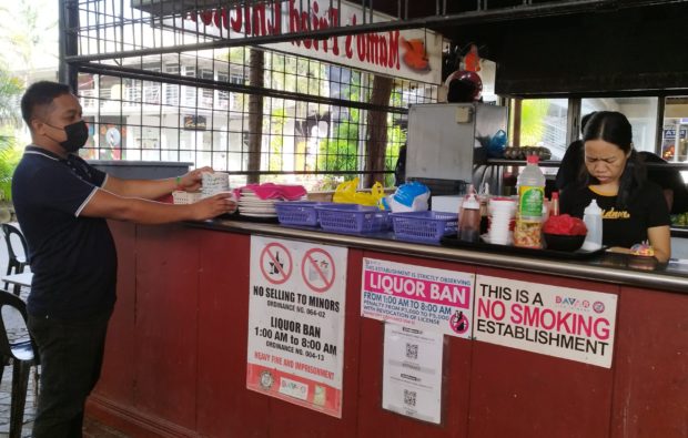 Workers at a liquor store inside Matina Town Square in Taboan, Davao City, prepare for opening hours on Monday amid an order from Mayor Sebastian Duterte to strictly enforce the liquor ban from 1 a.m. to 8 a.m. STORY: Strict liquor ban up in Davao City