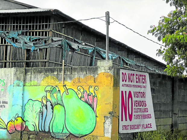 A suspected contaminated farm in Sto. Tomas town, Pampanga province, gets a sign warning against entry and other precautions after health authorities detected cases of bird flu in the area. STORY: In Pampanga, bird flu hits farms anew