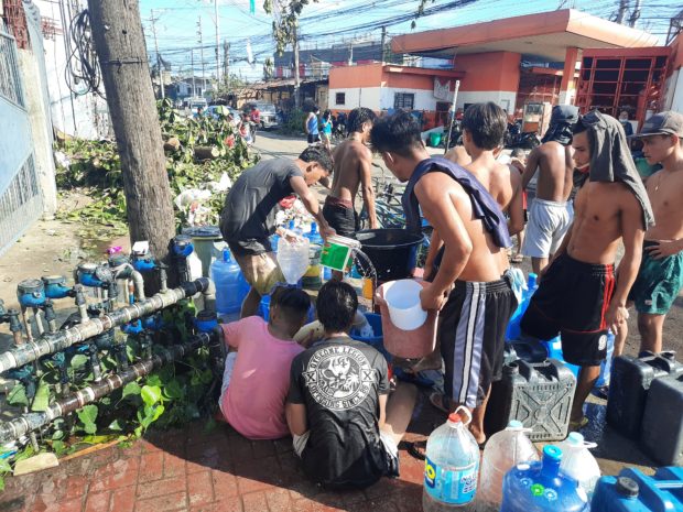 Cebu resident fetching water at a communal faucet. STORY: Higher water rates loom in Metro Cebu