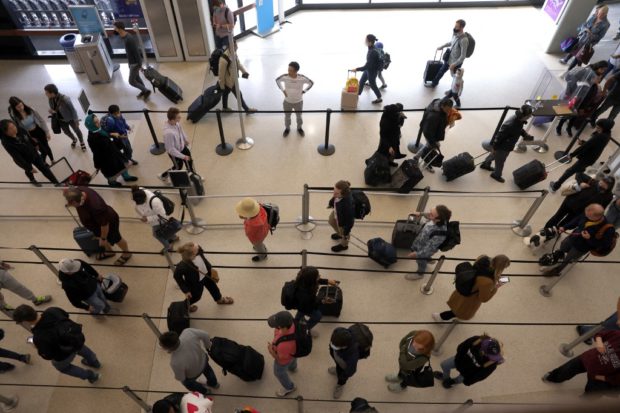 JULY 01: Travelers line up to enter a security checkpoint at San Francisco International Airport on July 01, 2022 in San Francisco, California. 