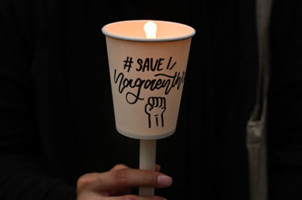 An activist holds a candle during a vigil against the impending execution of Malaysian national Nagaenthran K. Dharmalingam, sentenced to death for trafficking heroin into Singapore, outside the Singaporean embassy in Kuala Lumpur on November 8, 2021. 