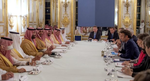 A handout picture provided by the Saudi Royal Palace shows French President Emmanuel Macron and members of his government meeting with Saudi Crown Prince Mohammed bin Salman and his delegation in Paris on July 28, 2022.