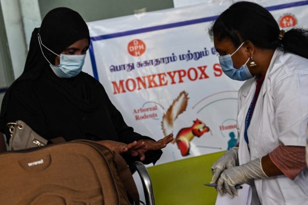 Health workers screen passengers arriving from abroad for Monkeypox symptoms at Anna International Airport terminal in Chennai