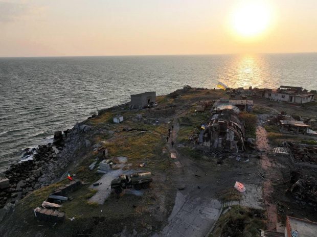 This handout picture taken and released by State Border Guard Service of Ukraine on July 7, 2022 shows the Ukrainian flag set on Bile village on Snake Island, Odessa region in Black Sea.
