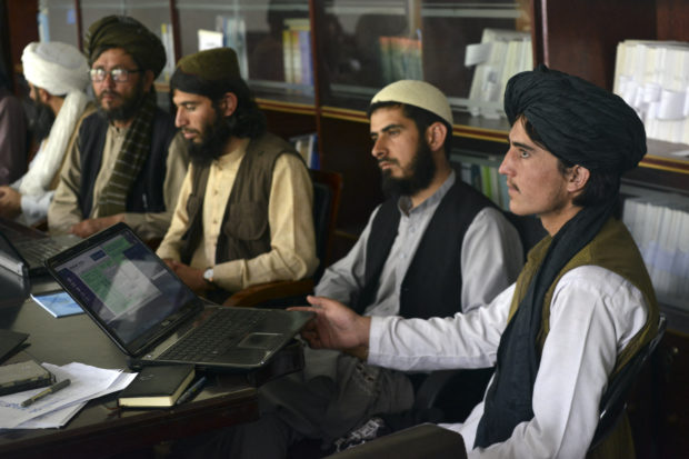 Taliban fighters swap arms for books as hundreds return to school