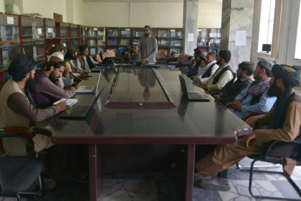 Taliban fighters swap arms for books as hundreds return to school