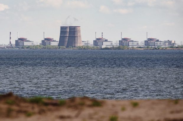 (FILES) In this file photo taken on April 27, 2022 shows a general view of the Zaporizhzhia nuclear power plant, situated in the Russian-controlled area of Enerhodar, seen from Nikopol. - Russian occupation authorities at Ukraine's Zaporizhzhia nuclear power plant said on August 7, 2022, a strike by Ukrainian forces damaged administrative buildings inside the complex. Zaporizhzhia -- Europe's largest atomic power complex that was occupied by Russia early in its offensive -- has in recent days been the scene of military strikes that have damaged several structures, forcing the shutdown of a reactor. (Photo by Ed JONES / AFP)