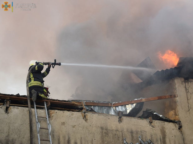 A firefighter works to douse a fire in a building, as Russia's attack on Ukraine continues, in Mykolaiv, in this handout picture released on July 31, 2022. State Emergency Service of Ukraine in Mykolaiv Region/Handout via REUTERS