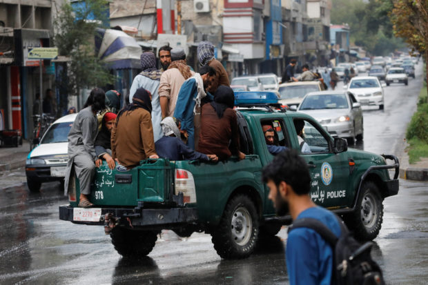 Taliban fighters drive a car on a street following the killing of Al Qaeda leader Ayman al-Zawahiri in a U.S. strike over the weekend, in Kabul, Afghanistan, August 2, 2022. REUTERS/Ali Khara