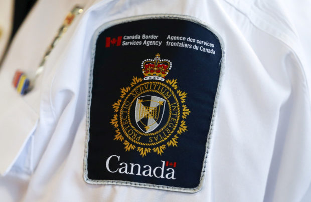 A Canada Border Services Agency (CBSA) logo is seen on a worker in Mississauga, Ontario, December 8, 2015. REUTERS/Mark Blinch