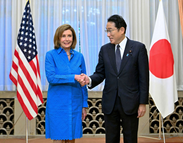 U.S. House of Representatives Speaker Nancy Pelosi shakes hands with Japan's Prime Minister Fumio Kishida before their breakfast meeting at Kishida's residence in Tokyo, Japan August 5, 2022, in this photo released by Kyodo. Mandatory credit Kyodo via REUTERS