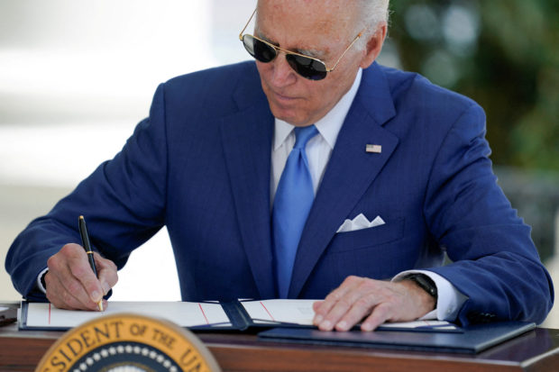 U.S President Joe Biden signs two bills aimed at combating fraud in the COVID-19 small business relief programs at the White House in Washington, U.S., August 5, 2022. Evan Vucci/Pool via REUTERS/File Photo