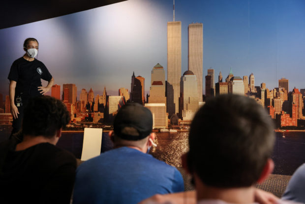 FILE PHOTO: Students listen as docent Joan Mastropaolo shares her first-person account of the attacks on September 11, 2001 during a tour at the 9/11 Tribute Museum in New York City, U.S., August 26, 2021. REUTERS/Caitlin Ochs