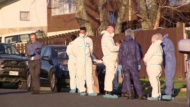 FILE PHOTO: Police and forensic investigators gather at the scene where suitcases with the remains of two children were found, after a family, who are not connected to the deaths, bought them at an online auction for an unclaimed locker, in Auckland, New Zealand, August 11, 2022 in this still image taken from video. TVNZ/Handout via REUTERS TV