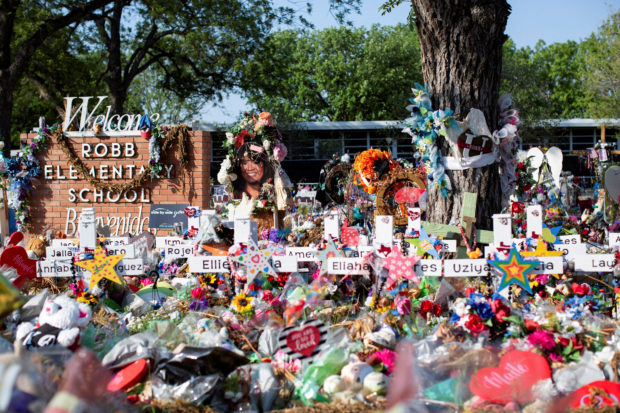 FILE PHOTO: Privacy barriers and bike racks maintain a perimeter at a memorial outside Robb Elementary School, after a video was released showing the May shooting inside the school in Uvalde, Texas, U.S., July 13, 2022. REUTERS/Kaylee Greenlee Beal
