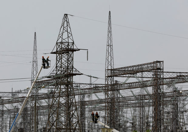 Employees work on electricity networks near the Zaporizhzhia Nuclear Power Plant in the course of Ukraine-Russia conflict outside the Russian-controlled city of Enerhodar in Zaporizhzhia region, Ukraine August 22, 2022. REUTERS/Alexander Ermochenko