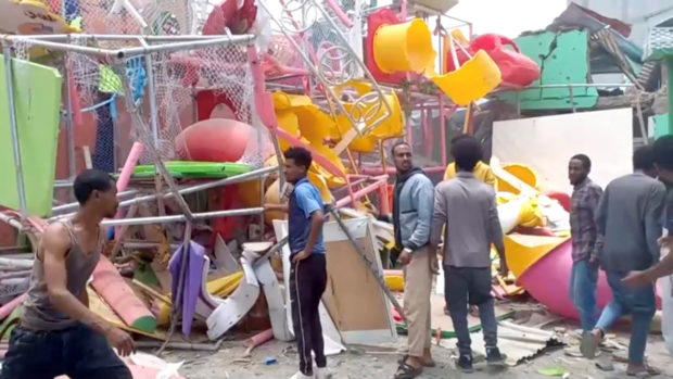 People inspect a damaged playground following an air strike in Mekelle, the capital of Ethiopia's northern Tigray region, August 26, 2022 in this still image taken from video. Tigrai TV/Reuters TV via REUTERS