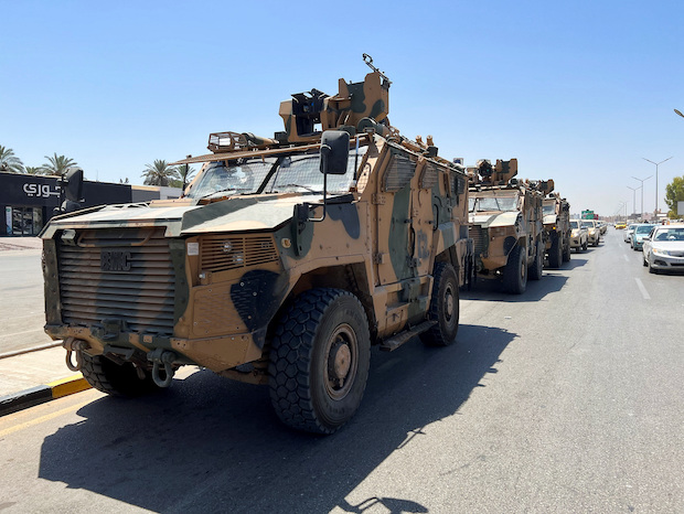 Military vehicles of the Libyan armed unit prepare to enter the area of clashed in Tripoli