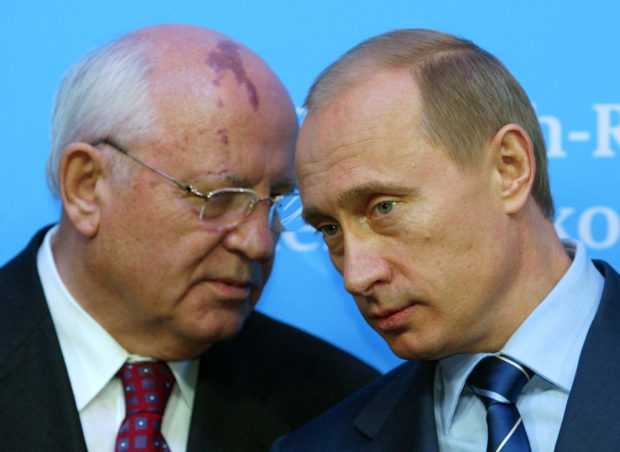 FILE PHOTO: Russian President Vladimir Putin (R) listens to former President of the Soviet Union Mikhail Gorbachev during a news conference following bilateral talks with German Chancellor Gerhard Schroeder at Schloss Gottorf Palace in the northern German town of Schleswig, Germany December 21, 2004. REUTERS/Christian Charisius