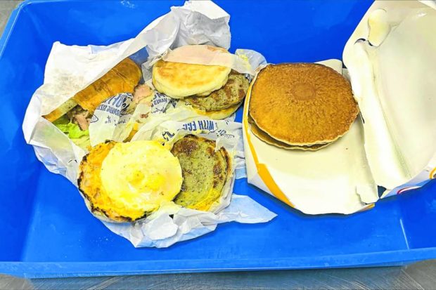 This undated handout photograph released by Australia’s Ministry of Agriculture on Aug. 1 shows breakfast items from a fast-food restaurant seized by Australian border guards from a traveler arriving from Indonesia, as part of strict biosecurity laws upon entering the country, at Darwin airport. STORY: Contraband McMuffins cost traveler to Australia $2,000