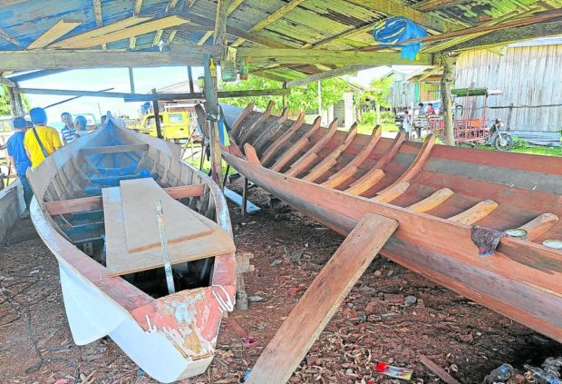 A pair of “kumpit,” or unfinished “lansa,” is kept under a shed in Bongao, Tawi-Tawi’s capital