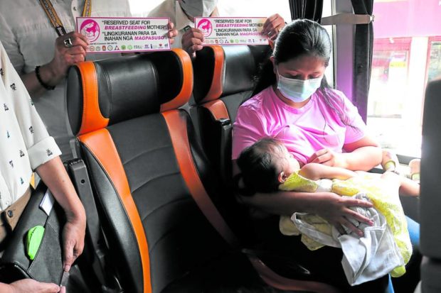 DEDICATED AREA A mother breastfeeds her child inside a bus during the Aug. 1 launching in Cagayan de Oro City of the designated seats for breastfeeding mothers in public buses in Northern Mindanao. —CONTRIBUTED PHOTO