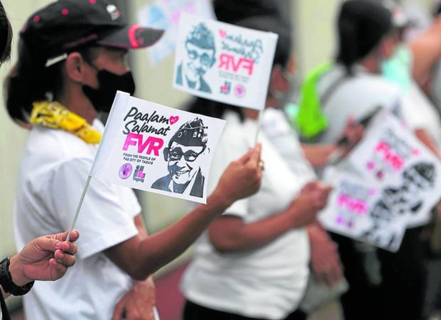 SOMBER SENDOFF A crowd of about 300 Taguig City residents line the road going into Libingan ng mga Bayani for the state funeral of former President Fidel V. Ramos on Tuesday. —MARIANNE BERMUDEZ