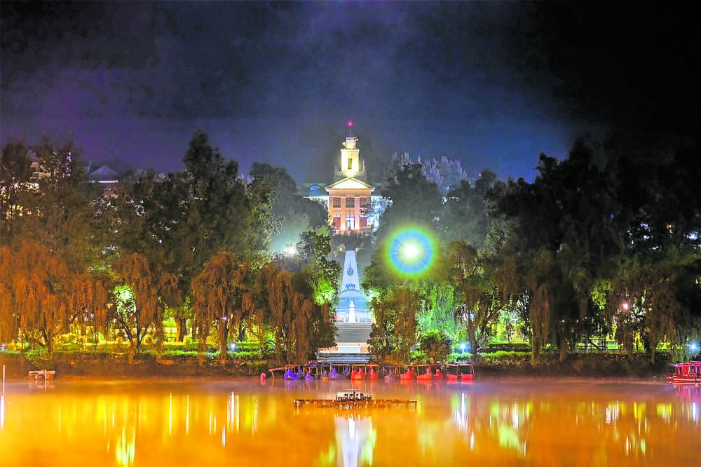 The Baguio City Hall is aglow at night, as seen from the Burnham Lake 
