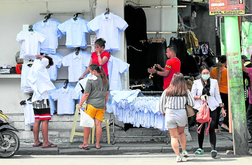 Photo of parents buying school uniforms for story:DepEd: 46% of schools ready for in-person classes, 5 days a week