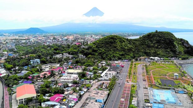 Mayon Volcano, which towers over Albay’s provincial capital Legazpi City, as shown in this photo in July, has been placed under alert level 1 on Sunday after the lava dome at its crater showed signs of collapsing and cascading through slopes facing the city and nearby Sto. Domingo town. STORY: Lava dome collapse feared in Mayon Volcano