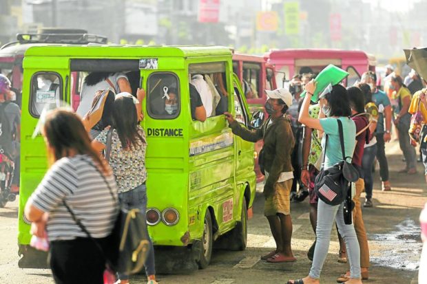 Commuters in Davao City push and shove to board public utility vehicles during rush hours 
